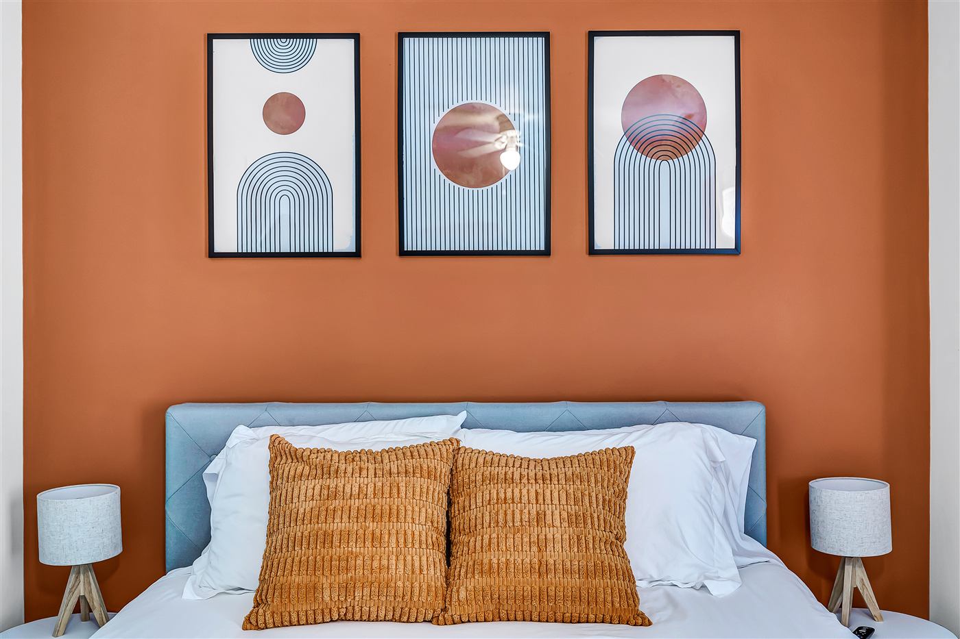 Bedroom with terracotta accent wall at Central Work-Friendly Stay
